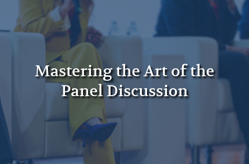 "Three panelists seated on stage chairs hold microphones, with the text 'Mastering the Art of the Panel Discussion' overlaid, conveying professionalism."