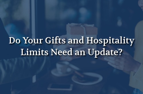 A hand presents a wrapped gift to another hand against a blurred background. Text overlay reads, "Do Your Gifts and Hospitality Limits Need an Update?"