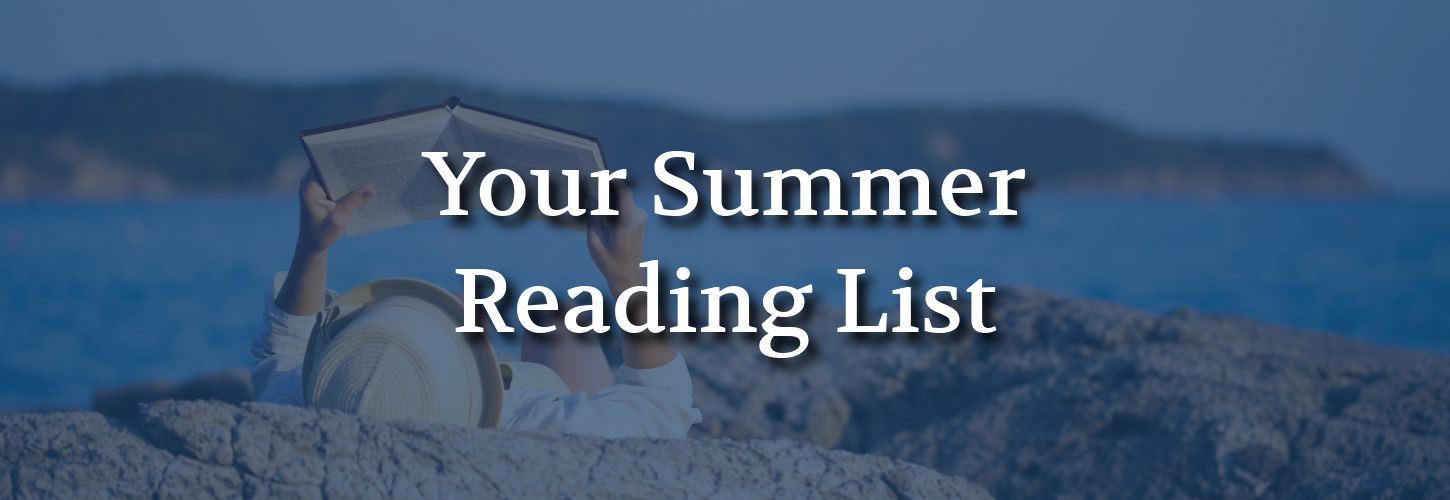 Person reading a book while lying on a rocky beach, wearing a straw hat. The text "Your Summer Reading List" overlays the serene ocean backdrop.